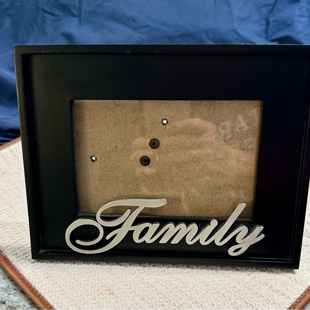 Family Photo Frame. Black wooden frame. Family in script writing made of pewter.